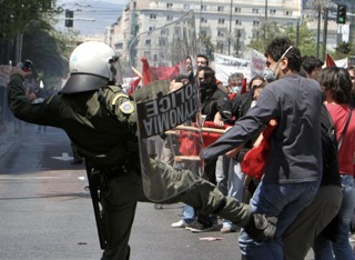 Policeman kicking a protester during an anti-austerity demonstration in Athens in May 2010. (Photo by Milos Bicanski /Getty Images)